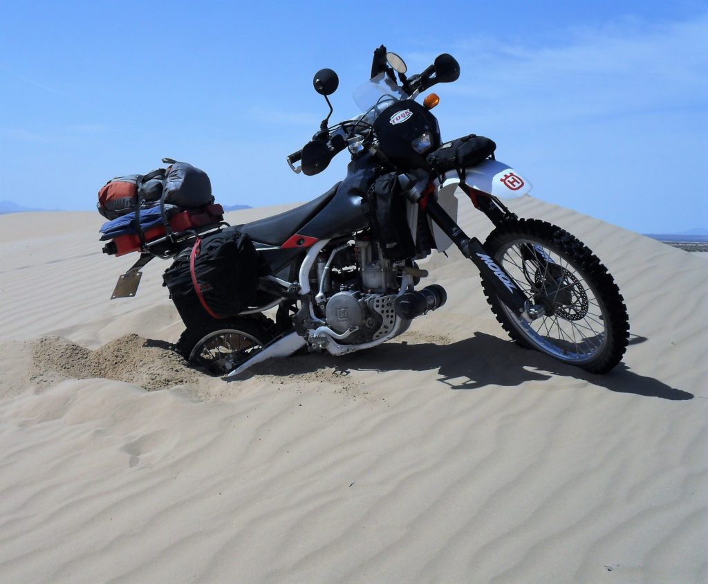 motorcycle overloaded in sand